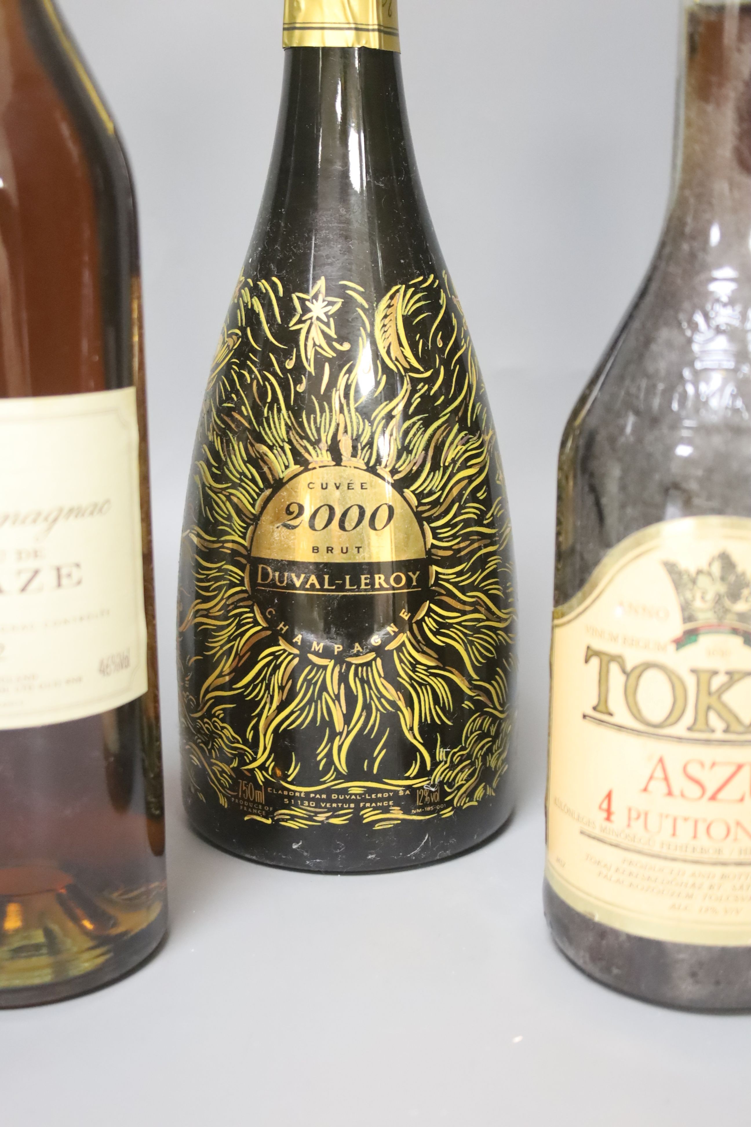 One bottle of Gould Campbell 1977 Vintage Port, one Domaine Le Basque Armagnac 1979, one Chateau de Lacaze Armagnac, 1982, one Tokaji, 1990, one Graham's Extra Dry Port and one Duvall Leroy 2000 Champagne.